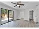 Primary bedroom with a ceiling fan, closet, access to en suite bathroom, and access to outdoor patio at 2 Rollingwood Trl, Deland, FL 32724