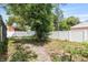 Backyard featuring a grassy area, a mature tree, and a white privacy fence at 229 Bitterwood St, Winter Springs, FL 32708