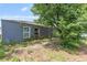 Image of the side of the home and overgrown yard at 229 Bitterwood St, Winter Springs, FL 32708