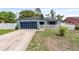 Charming home with blue accents, a unique black garage door, and white picket fence at 229 Bitterwood St, Winter Springs, FL 32708