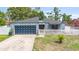 Beautiful home with blue accents, a unique black garage door, and white picket fence at 229 Bitterwood St, Winter Springs, FL 32708