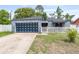 Charming one-story home with blue accent garage door, picket fence and well-maintained front yard at 229 Bitterwood St, Winter Springs, FL 32708
