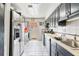 Kitchen with sleek black cabinets, stainless steel appliances, and tile flooring at 229 Bitterwood St, Winter Springs, FL 32708