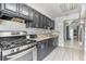 Efficient kitchen featuring modern appliances, dark cabinets, and a practical layout for cooking at 229 Bitterwood St, Winter Springs, FL 32708