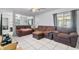 Cozy living room featuring a large window and comfortable brown seating, creating an inviting space at 229 Bitterwood St, Winter Springs, FL 32708