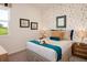 Cozy bedroom with a decorative wallpaper, comfortable bedding, and natural light at 2500 Raghav Trail Cir, Tavares, FL 32778