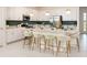 Modern, eat-in kitchen with white cabinets, stainless steel appliances, and stylish pendant lighting at 2500 Raghav Trail Cir, Tavares, FL 32778