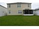 Spacious backyard featuring a well-maintained lawn, screened-in porch and neutral exterior at 3074 Royal Tern Dr, Winter Haven, FL 33881