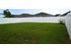 Picture of a fenced backyard featuring a lush green lawn and well-maintained vinyl fencing at 3074 Royal Tern Dr, Winter Haven, FL 33881