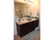 Bathroom featuring a double sink with granite countertops and walk-in shower at 3074 Royal Tern Dr, Winter Haven, FL 33881