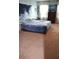 Spacious bedroom featuring carpet, large window with curtains, and a wave tapestry at 3074 Royal Tern Dr, Winter Haven, FL 33881