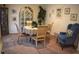 Charming dining room with seating for four, lovely china cabinet, attractive wall art, and blue accent chair at 3074 Royal Tern Dr, Winter Haven, FL 33881