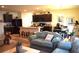 Spacious open-concept living area with dark cabinets, island seating, dining area and comfortable seating at 3074 Royal Tern Dr, Winter Haven, FL 33881