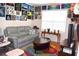 Comfortable living room with a sofa, coffee table, TV, and colorful wall decor at 3074 Royal Tern Dr, Winter Haven, FL 33881