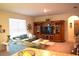 Comfortable living room area featuring a large built-in entertainment center and cozy seating arrangement at 3074 Royal Tern Dr, Winter Haven, FL 33881