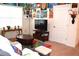 Cozy living room decorated with wall art, a TV, comfortable seating, and a bright rug at 3074 Royal Tern Dr, Winter Haven, FL 33881