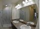 Modern bathroom with double sinks and a glass-enclosed shower at 3308 Rodrick Cir, Orlando, FL 32824