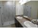 Modern bathroom with double sinks and a glass-enclosed shower at 3308 Rodrick Cir, Orlando, FL 32824
