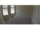 Bedroom with two windows providing ample natural light and a view of the neighborhood at 3308 Rodrick Cir, Orlando, FL 32824
