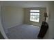 Neutral bedroom features a large window providing lots of natural light and neutral carpet at 3308 Rodrick Cir, Orlando, FL 32824