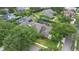 Aerial view of a home with lush greenery, a screened pool, a solar panel array, and a well-maintained yard at 3372 Bellington Dr, Orlando, FL 32835
