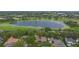 Aerial view of the property showcasing its prime location on a lake with lush green surroundings at 3372 Bellington Dr, Orlando, FL 32835