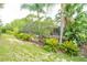 Lush backyard featuring a screened-in pool with tropical landscaping providing privacy and shade at 3372 Bellington Dr, Orlando, FL 32835