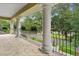 Elegant covered balcony with decorative iron railing and columns, offering a serene outdoor space overlooking the neighborhood at 3372 Bellington Dr, Orlando, FL 32835