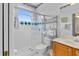 Bathroom with a tiled shower, blue accents, and a furniture style shelving unit at 3372 Bellington Dr, Orlando, FL 32835