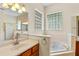 Bathroom featuring garden tub, block windows, vanity with sink, and gold faucet at 3372 Bellington Dr, Orlando, FL 32835