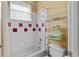 Clean bathroom with a tiled shower/tub combination and square decorative tile at 3372 Bellington Dr, Orlando, FL 32835