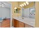 Bathroom featuring natural wood cabinets and a doorway to another room at 3372 Bellington Dr, Orlando, FL 32835