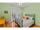 Cozy bedroom featuring a wrought iron bed frame, wood floors, and French doors to the exterior at 3372 Bellington Dr, Orlando, FL 32835