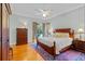 Bedroom with hardwood floors, a ceiling fan, and views of the pool at 3372 Bellington Dr, Orlando, FL 32835