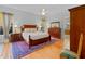 Bedroom with hardwood floors, a ceiling fan, and a large bed with nightstands at 3372 Bellington Dr, Orlando, FL 32835