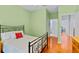 Bedroom featuring green walls, hardwood floors, and white trim at 3372 Bellington Dr, Orlando, FL 32835