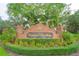 Elegant brick community entrance sign for Cypress Landing, framed by lush landscaping and mature trees at 3372 Bellington Dr, Orlando, FL 32835