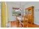 Bright dining area with hardwood floors, pool view, and classic wooden furniture at 3372 Bellington Dr, Orlando, FL 32835