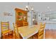 Cozy dining area with hardwood floors, open to the modern kitchen at 3372 Bellington Dr, Orlando, FL 32835