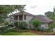 Elegant two-story home boasts a spacious balcony, lush landscaping, and a charming facade at 3372 Bellington Dr, Orlando, FL 32835