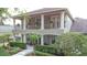 Stately two-story home with a covered porch, iron balcony railing and verdant landscaping at 3372 Bellington Dr, Orlando, FL 32835