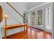 Bright foyer with hardwood floors, a staircase, and glass double doors at 3372 Bellington Dr, Orlando, FL 32835