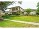 Beautiful home featuring a meticulously maintained front yard, mature trees and lush landscaping at 3372 Bellington Dr, Orlando, FL 32835