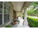 Charming covered front porch with decorative columns and large windows providing plenty of natural light at 3372 Bellington Dr, Orlando, FL 32835
