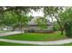 Three-car garage and tree framed side view of home at 3372 Bellington Dr, Orlando, FL 32835
