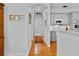 Bright hallway with hardwood floors, leading to the kitchen and bedrooms at 3372 Bellington Dr, Orlando, FL 32835