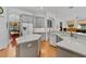 Open kitchen with island, gray cabinets, stainless steel appliances and adjacent dining area at 3372 Bellington Dr, Orlando, FL 32835