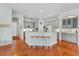 Spacious kitchen with island, breakfast bar, gray cabinetry, stainless steel appliances, hardwood floors at 3372 Bellington Dr, Orlando, FL 32835