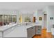 Kitchen featuring quartz countertops, island, breakfast bar and views of the screened-in pool at 3372 Bellington Dr, Orlando, FL 32835