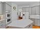 Modern kitchen with white countertops, stainless steel appliances, and ample cabinet space at 3372 Bellington Dr, Orlando, FL 32835